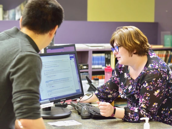 Two people looking at a computer together