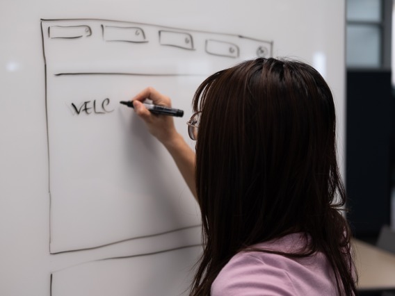 Person draws prototype on whiteboard. 