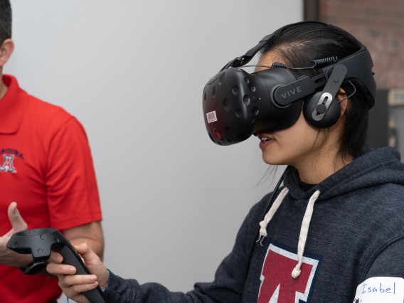 A student plays with a virtual reality (VR) headset in our VR Studio.