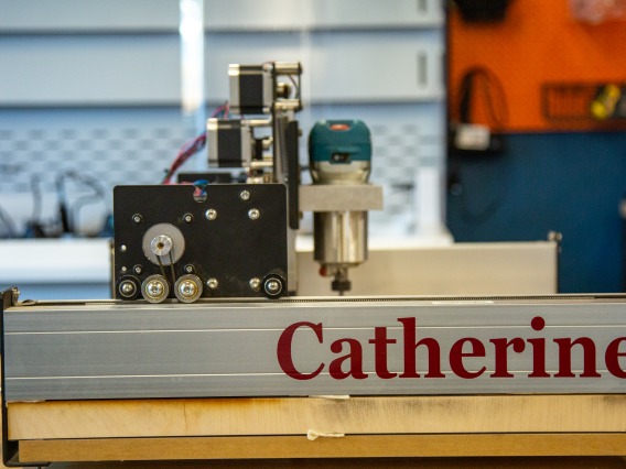 close up image of a CnC machine with red text on it saying "Catherine"