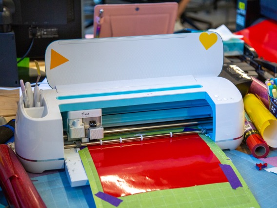 image of a vinyl cutter with craft supplies around it