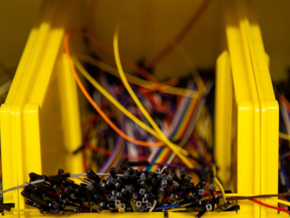 an image of a yellow bin containing parts for a circuit