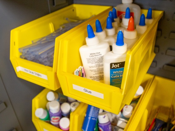 image of yellow bins containing different crafting items such as glue and markers