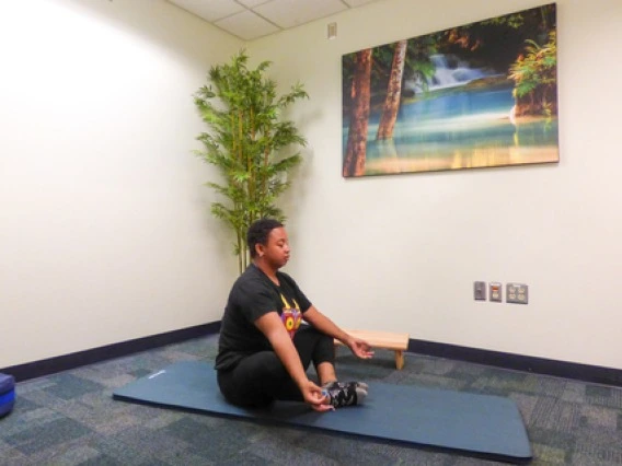 person sitting and meditating 