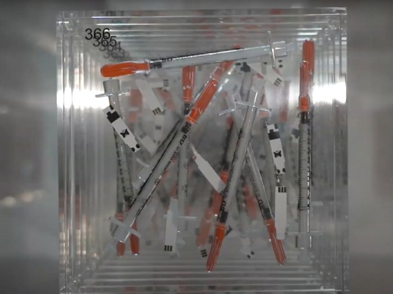needles displayed in acrylic block