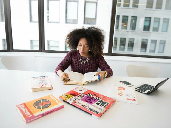 Woman studying with books on a table
