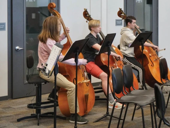 Students playing instruments in a SoundLok Sound Isolation Room.