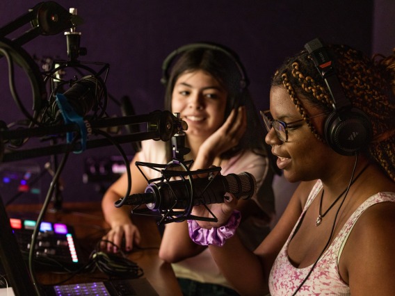 Two students using the podcasting equipment