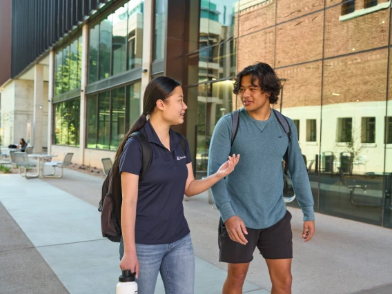 Two students talking on their way to class