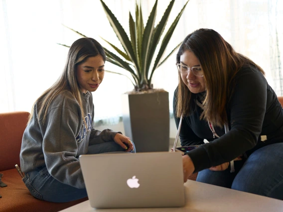 Two students looking at information online