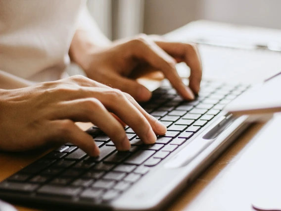 Close-up of person typing on keyboard