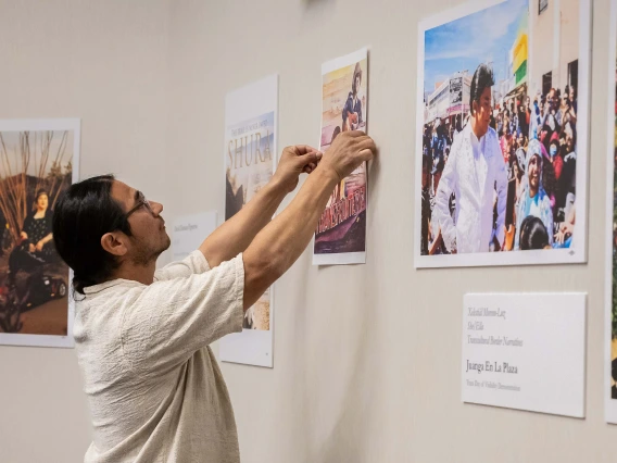 Reclaiming the Border Narrative Digital Archive launch party attendee admires artwork