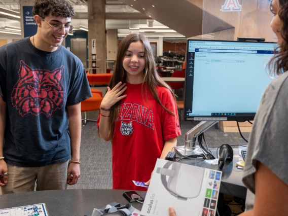 Two students at a reference desk