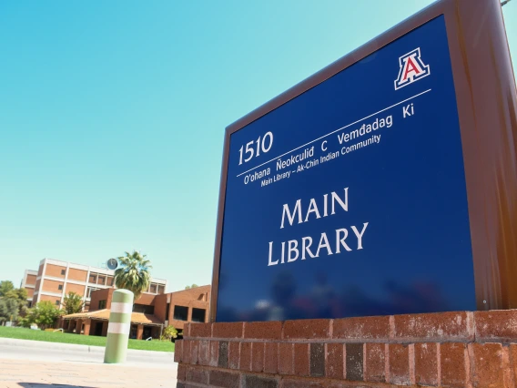 blue main library sign with O'odham translation at the top