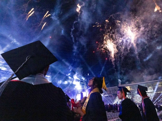 Night-time graduation at the University of Arizona with fireworks