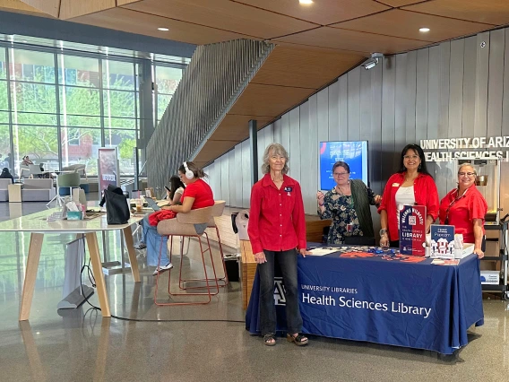 University Libraries employees posed in the lobby of the Health Science Library
