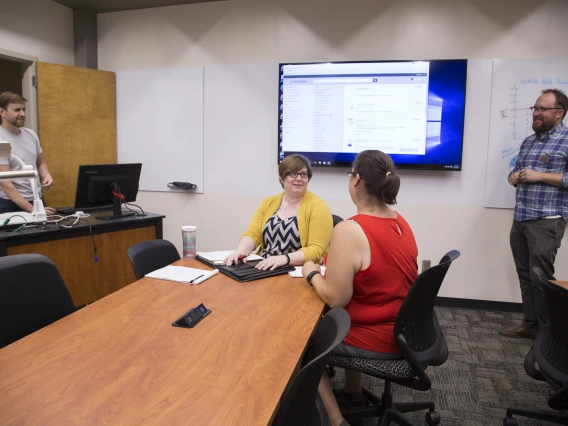 Faculty members using technology in the Collaborative Faculty Room