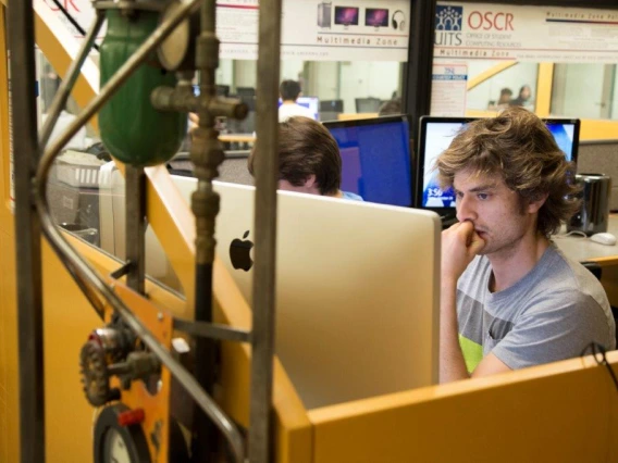 Student using a computer in the Multimedia Zone.