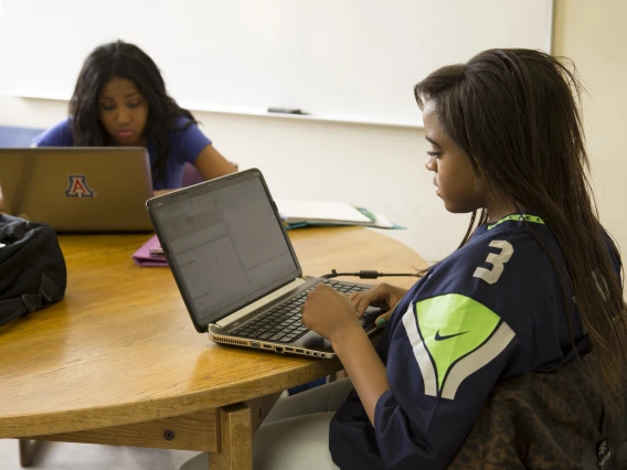 students at a table in a small group study room