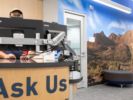 Staff standing behind Ask Us desk