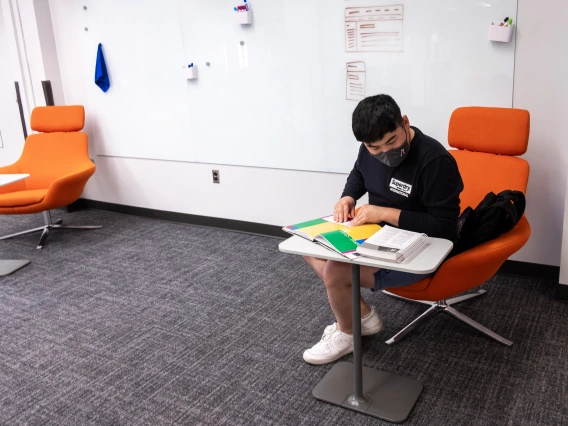 student reading in a comfortable chair