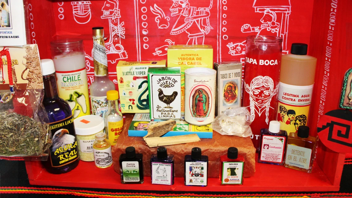 Bottles and candles displayed on a red cloth