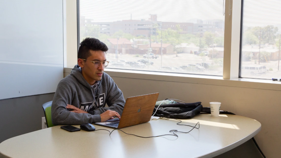 student sitting at study room table