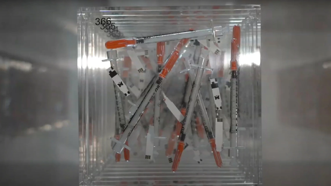 needles displayed in acrylic block