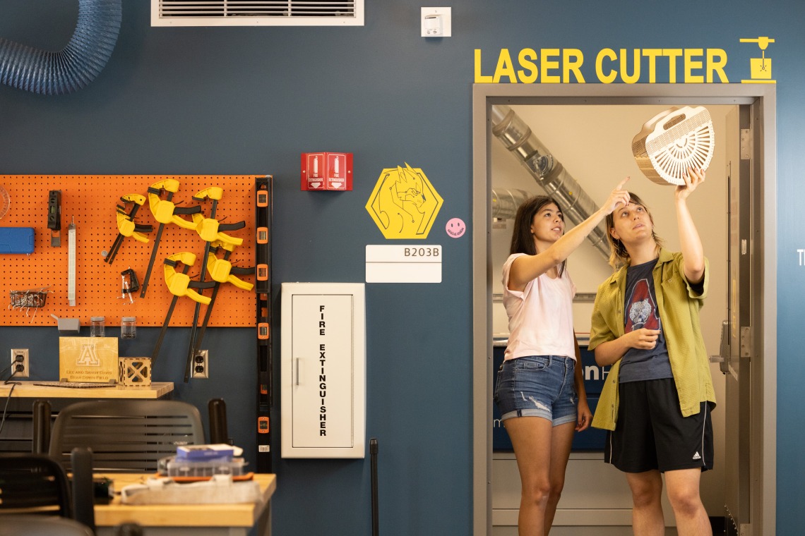 Students Looking at a Laser Cut Project
