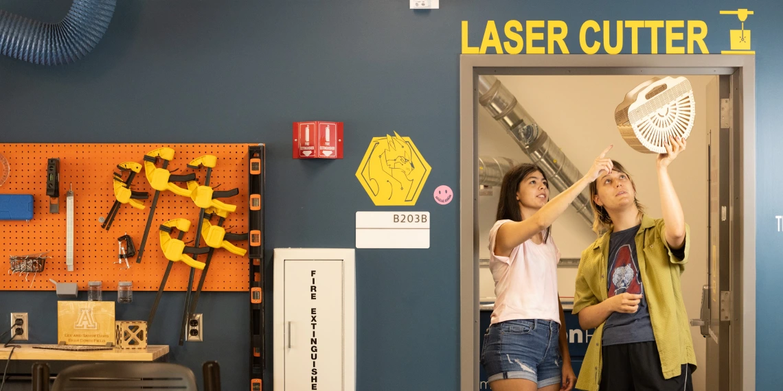 Students Looking at a Laser Cut Project