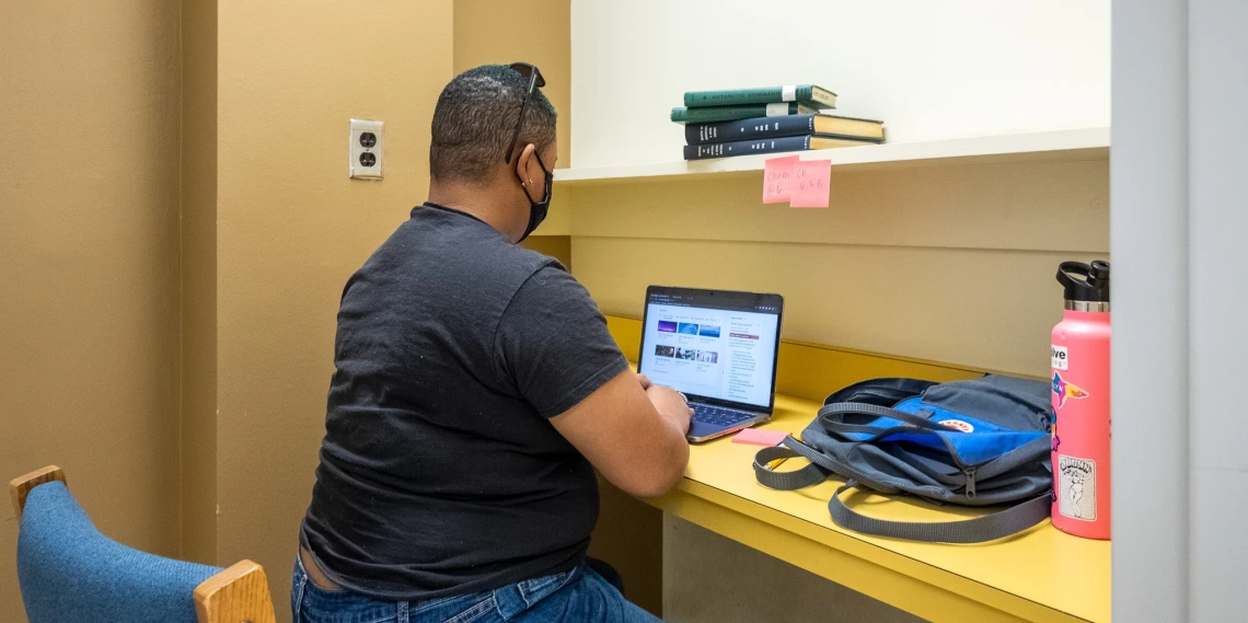 Student studying in a small long-term study room