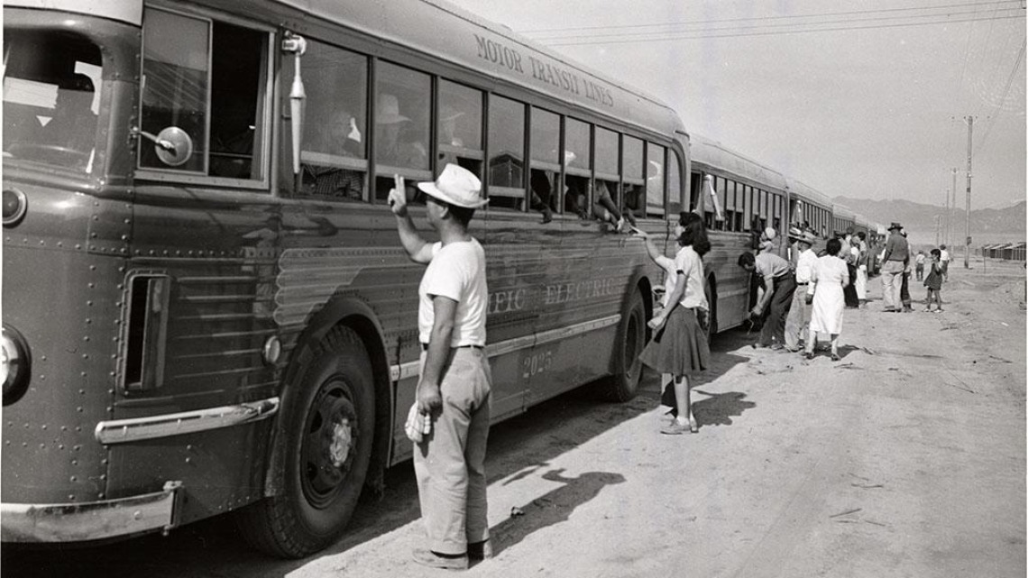 Black and white photo depicting buses carrying evacuees of Japanese ancestry arriving at the Colorado River Relocation Center in Poston, Arizona