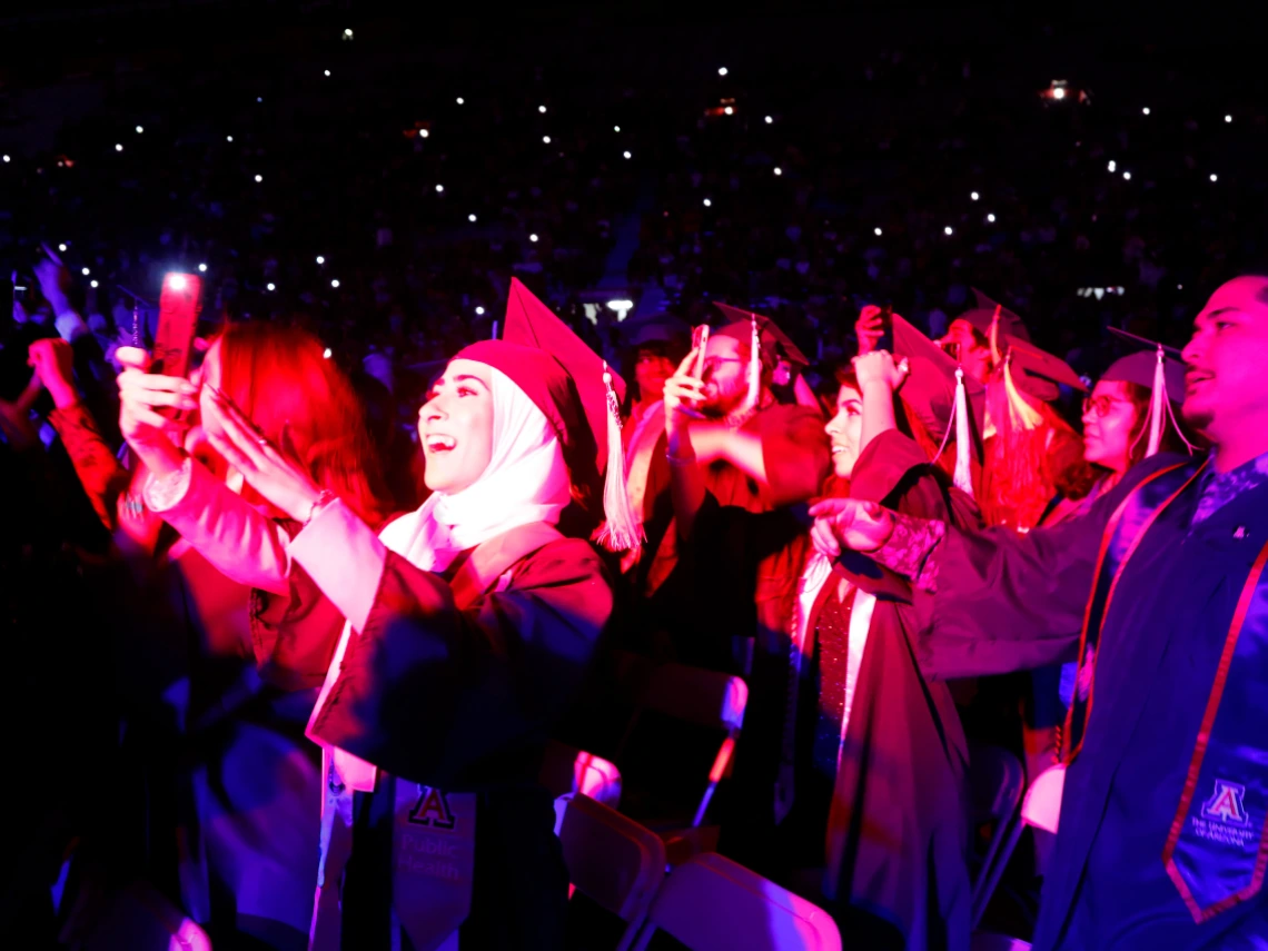 Group of graduating University of Arizona students at night