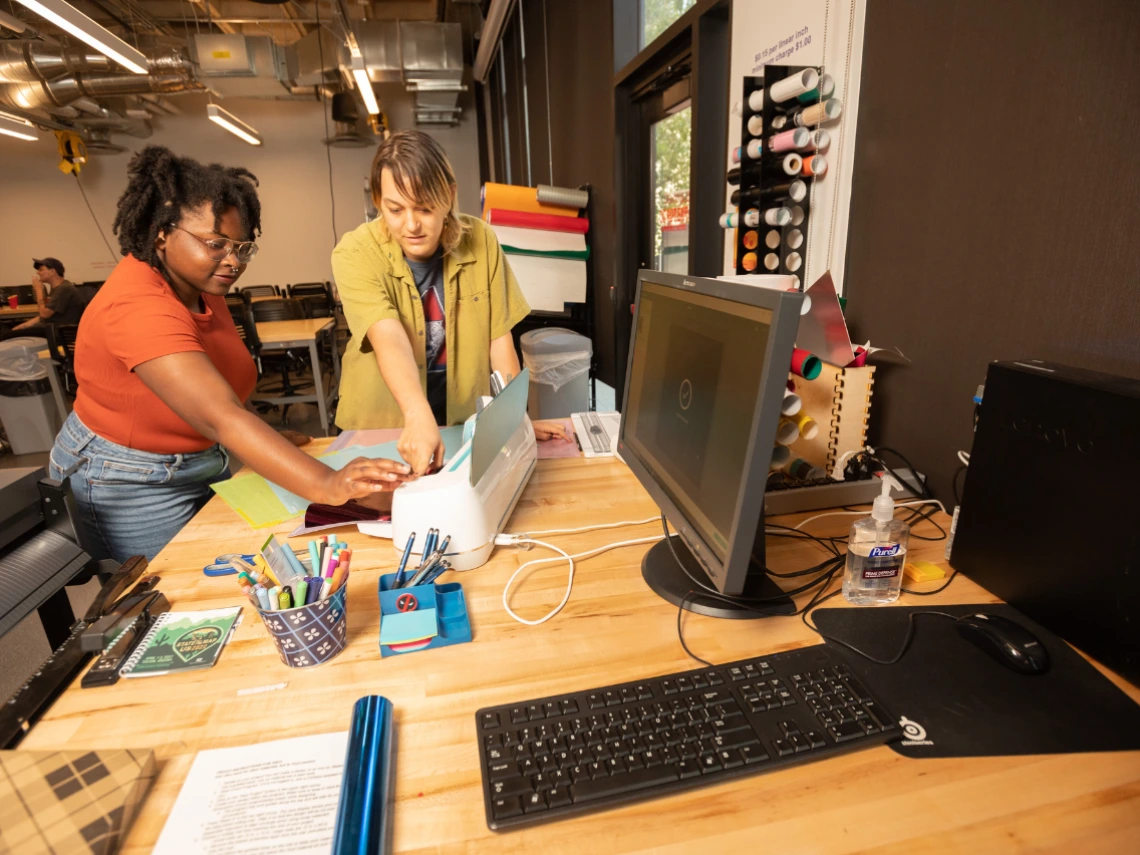 Two students working on a creative project in CATalyst Studios