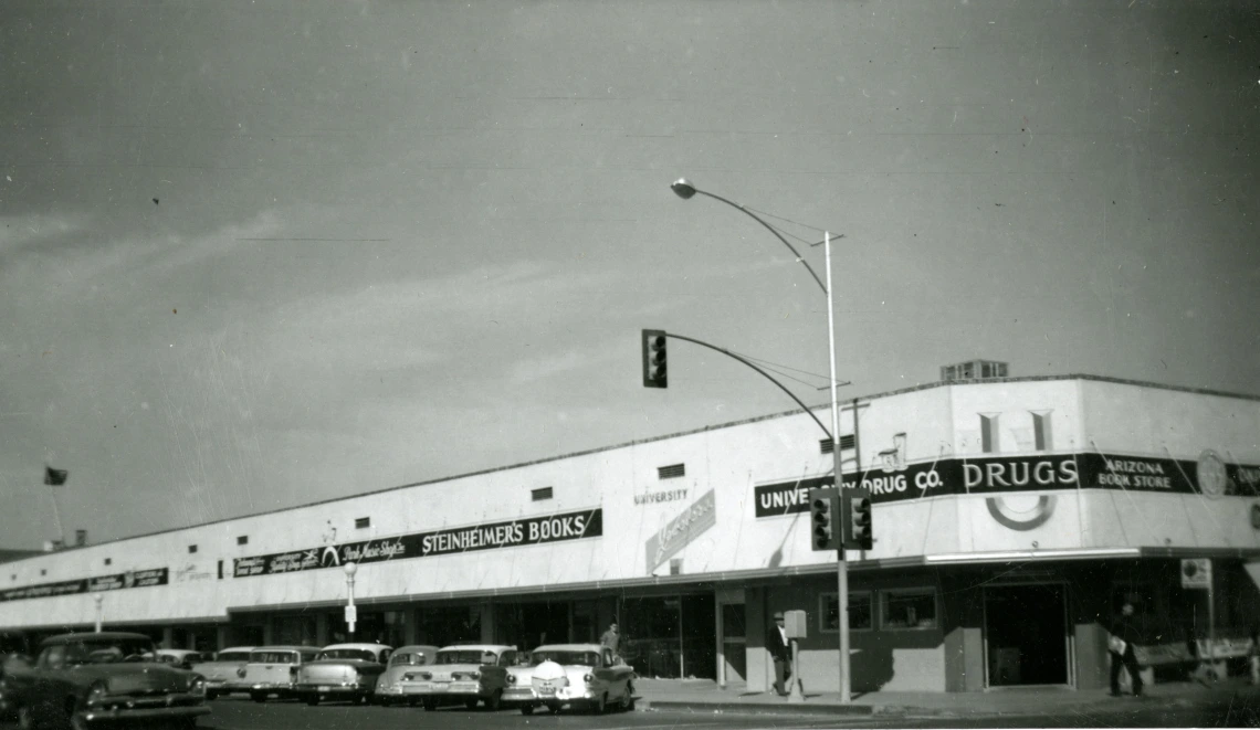 Black and white photo of shops at the corner of Park and University in Tucson, circa 1950s.