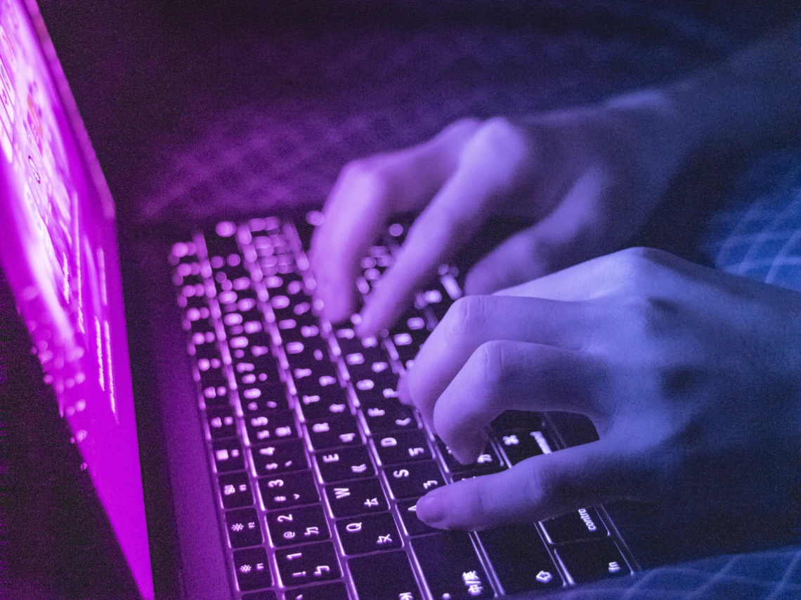 Close-up of person typing on keyboard