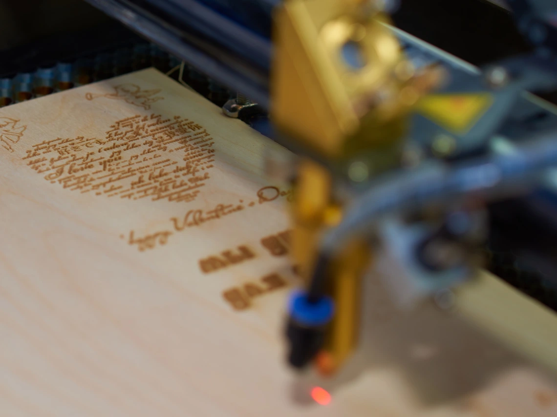 A very close-up image of a laser cutter cutting wood