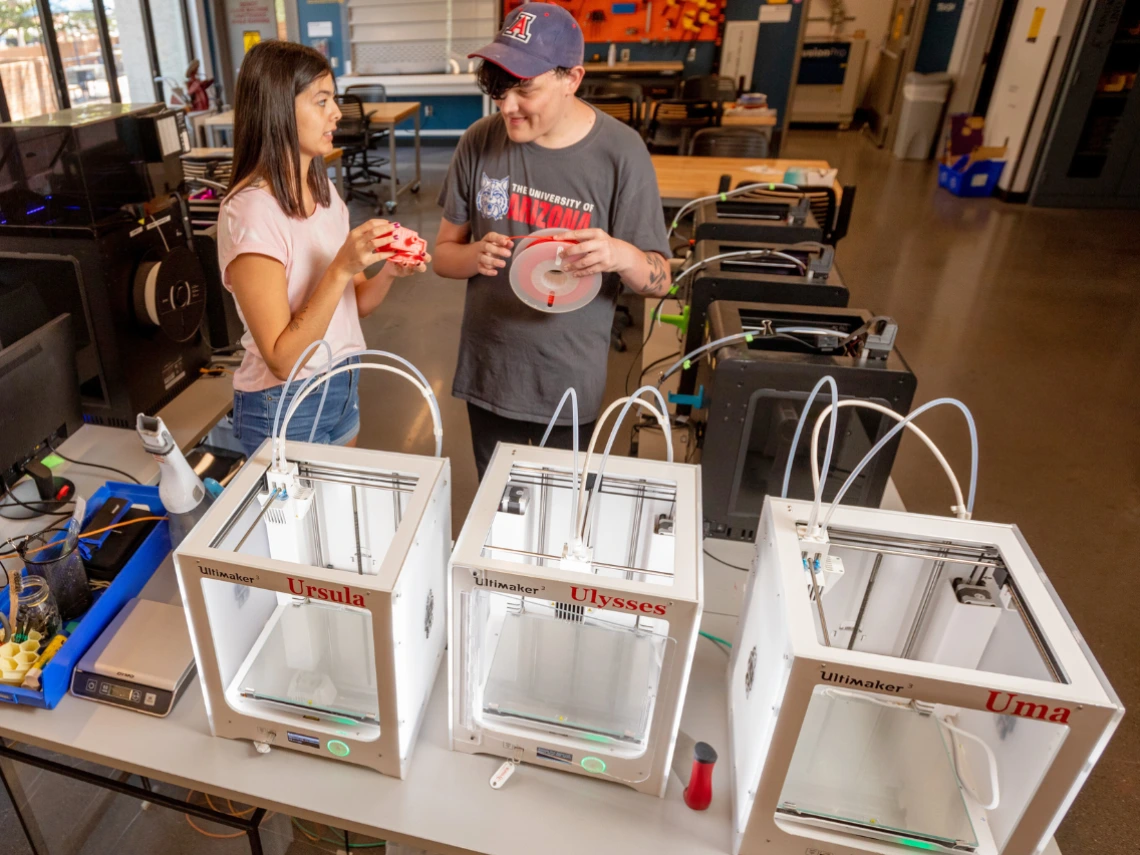 Two students are working at the 3D printers in CATalyst Studios