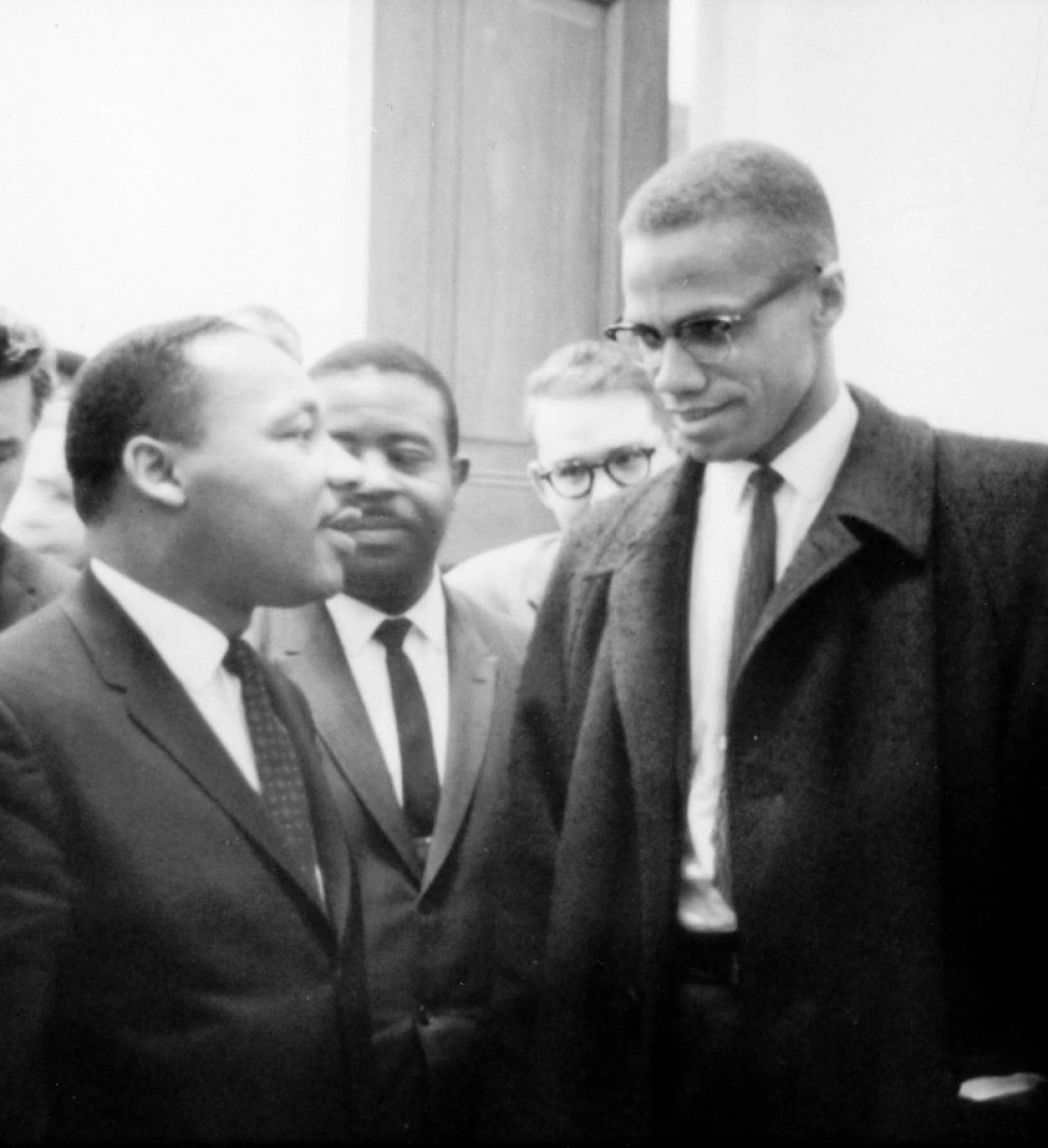 Photo of Martin Luther King, Jr. and Malcolm X waiting for press conference
