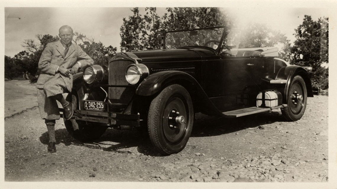 Photograph of Walt Coburn Leaning on a Packard Roadster, 1927