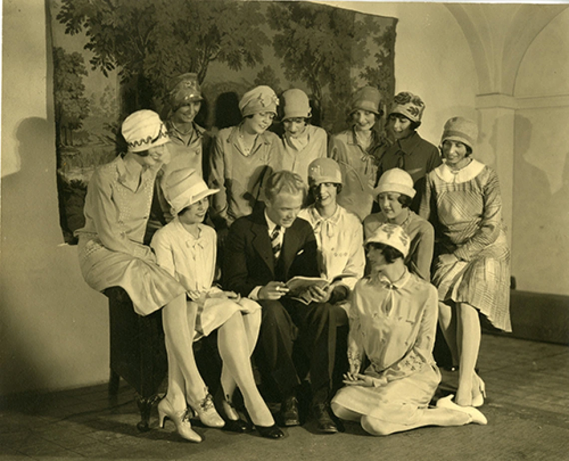 Girls Gathered Around Man Reading