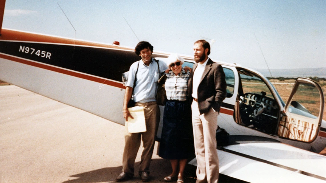 Three People Standing in front of Crashed Airplane, 1986