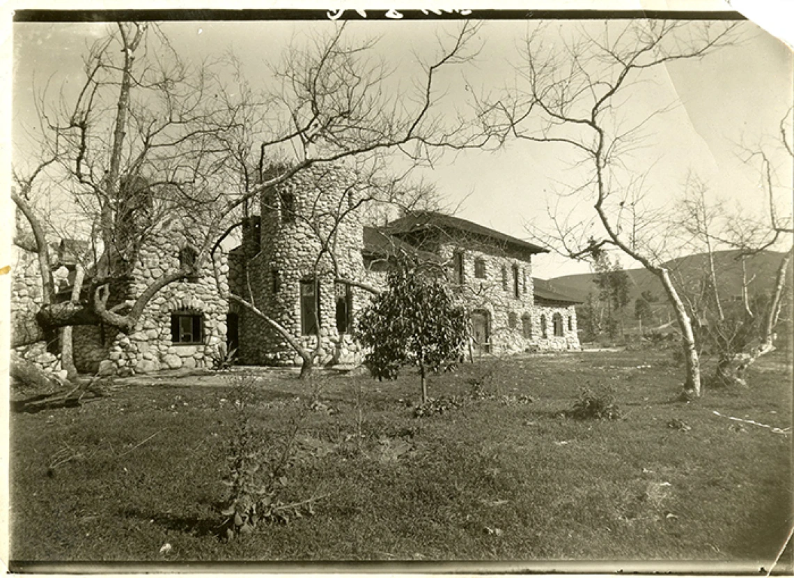 black and white photo of a large stone house