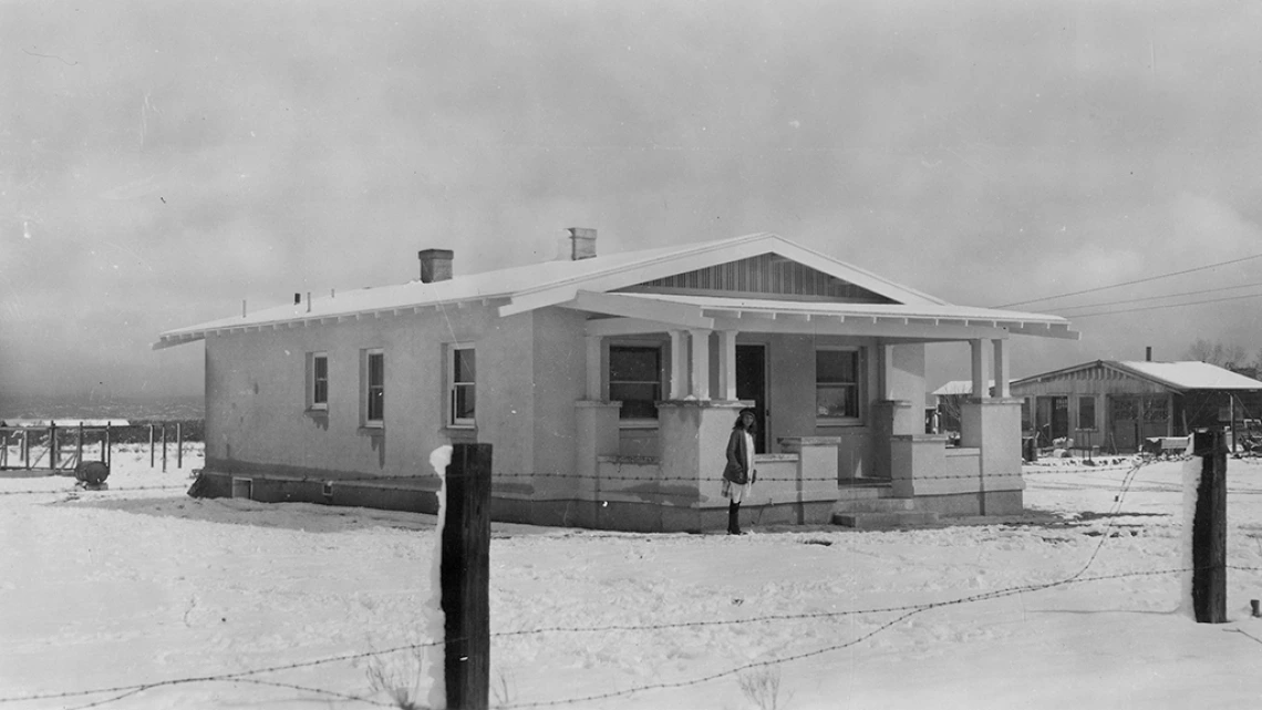 Meta Pape, daughter of Otto Pape, stands in front of their Tucson home in the snow, March 12, 1922