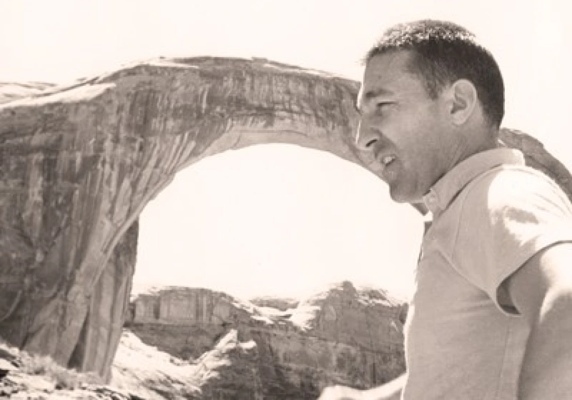Secretary of the Interior Udall touring Rainbow Bridge, Glen Canyon National Park, Utah; April 1961 Black and white photo of Stewart Udall with Rainbow Bridge, Glen Canyon National Park, Utah in the background; April 1961