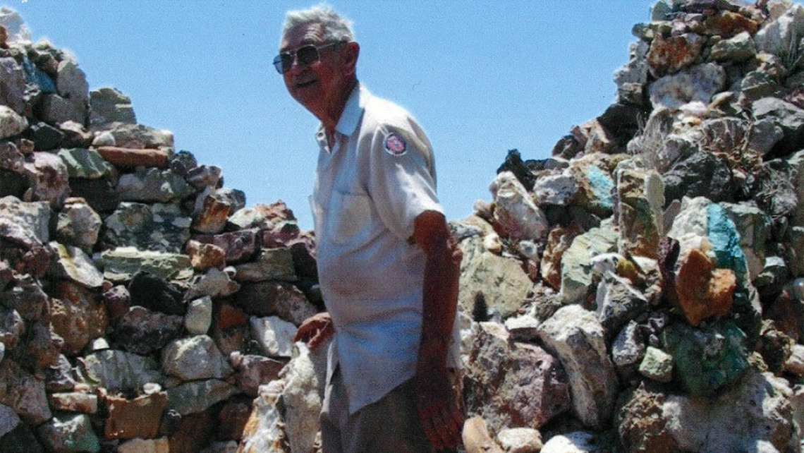 portrait of Harrison Yocum surrounded by piles of rocks