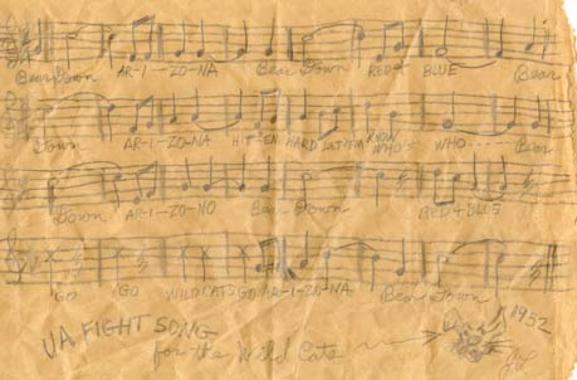 Music and lyrics of the "Bear Down, Arizona" fight song handwritten on a light brown paper bag 