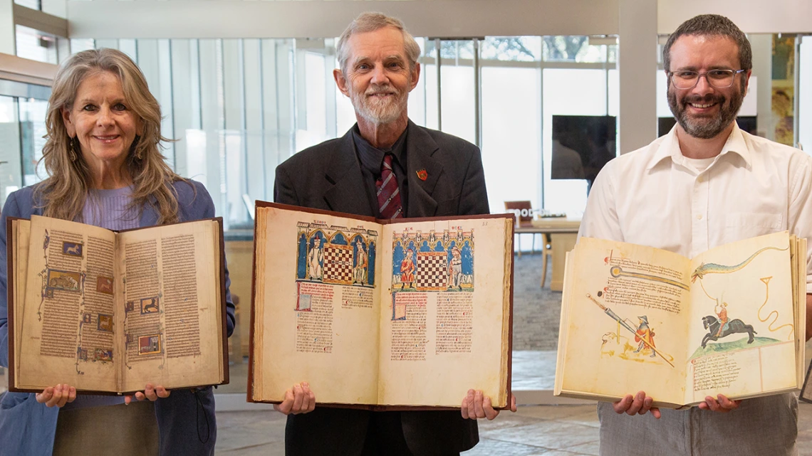 Cynthia White, Albrecht Classen, Paul Milliman holding books