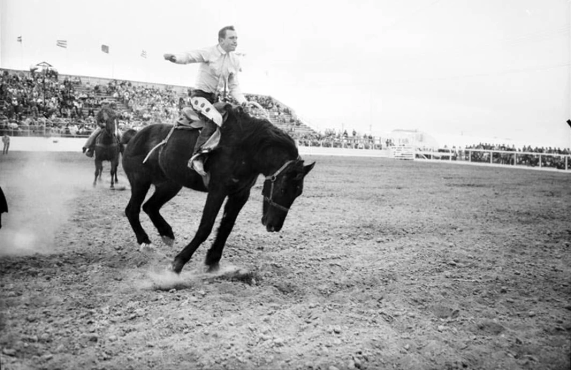 Photo of rodeo man on horse 1957