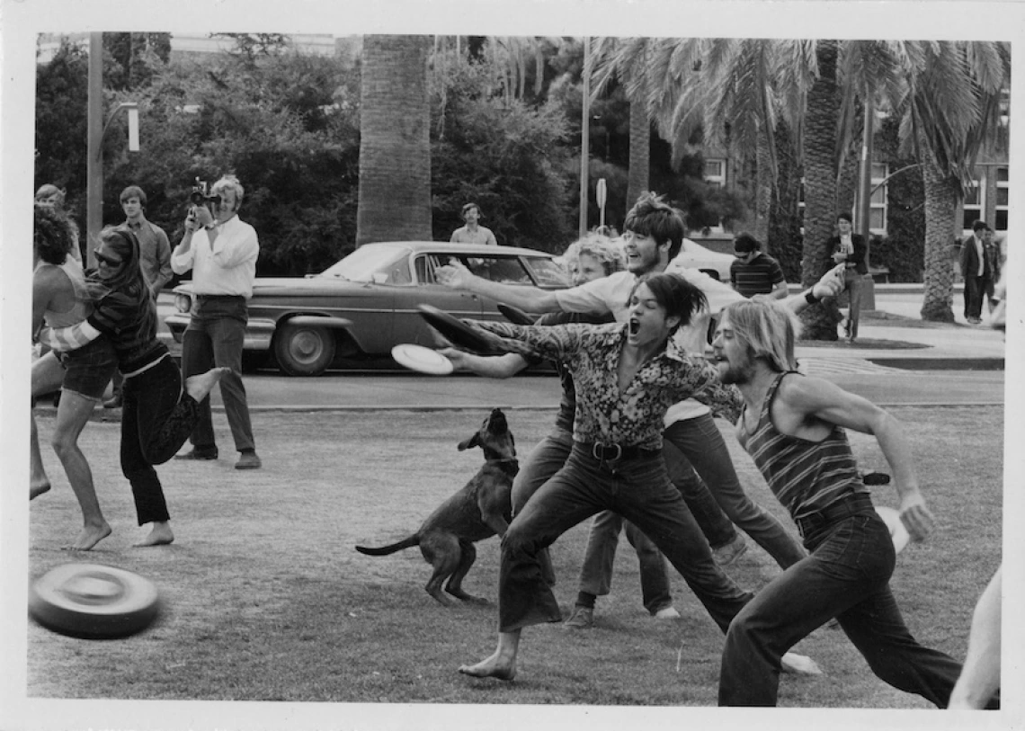 students playing frisbee on the university mall